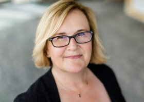 A woman poses for a professional photo.