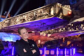 A woman poses in Disneyland.